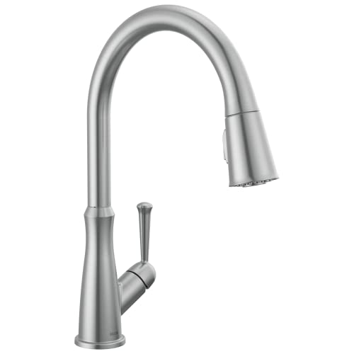 Brushed stainless steel kitchen faucet with curved gooseneck spout and single lever handle, spray head pulled down.