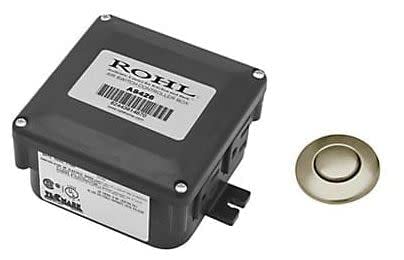 Black rectangular control box with white label and unlacquered brass air switch button.