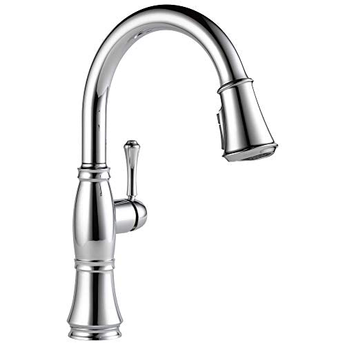 Chrome pull-down kitchen faucet with curved spout, single handle lever, and spray head extended to the right.