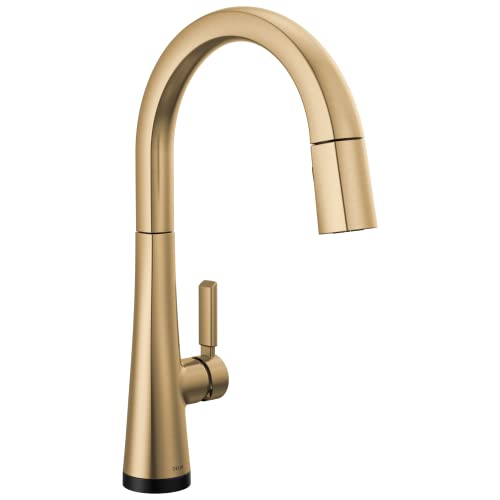 Champagne bronze single handle kitchen faucet with curved spout and pull-down spray head.