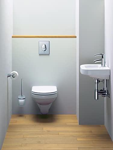 Chrome flush plate mounted on white bathroom wall above wall-hung toilet.