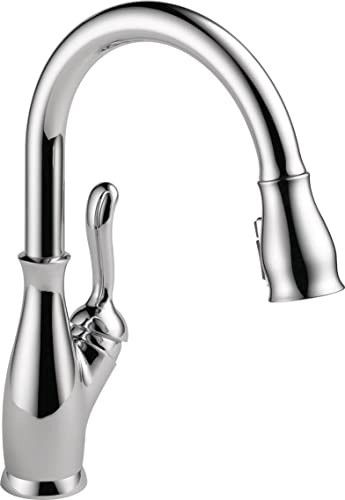 Chrome pull-down kitchen faucet with single handle and curved spout in polished finish.
