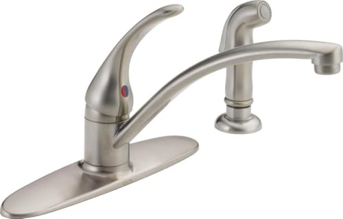 Brushed nickel single-handle kitchen faucet with curved spout and detachable spray head on deck plate.