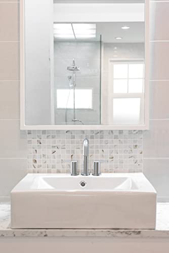 Chrome widespread bathroom faucet with two handles and pop-up drain installed on white rectangular sink.