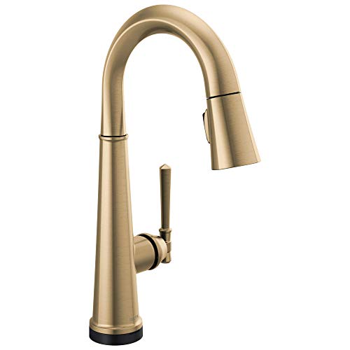 Champagne bronze single-handle kitchen faucet with curved spout and pull-down spray head.
