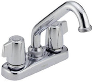 Chrome two-handle laundry faucet with curved spout and blade handles on white base.