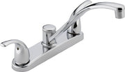 Chrome kitchen faucet with two handles and curved spout mounted on base plate.