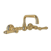 Polished brass wall-mount bridge faucet with U-shaped spout and lever handles.