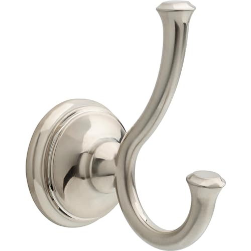 Brushed nickel double robe hook with curved arms mounted on round wall plate.