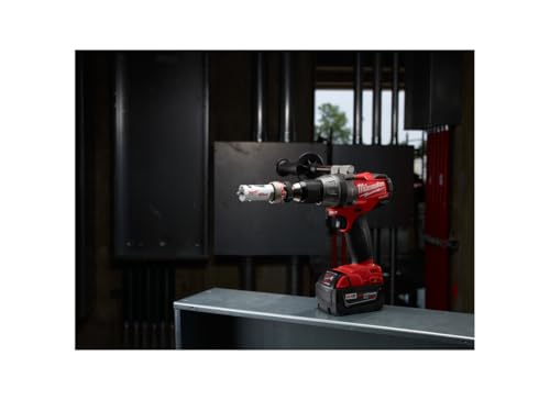 Milwaukee red and black cordless drill with hole saw bit attachment on workbench.