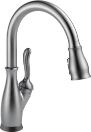 Chrome kitchen faucet with single curved handle and pull-down spray head.
