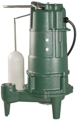 Green cast iron grinder pump with white collection basin and discharge pipe attachment.