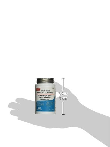Blue pipe joint compound sealant in 4 fl. oz. container with metal screw-top lid, shown in hand for scale.