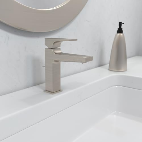 Brushed nickel single-hole bathroom faucet with lever handle and rectangular spout on white sink.