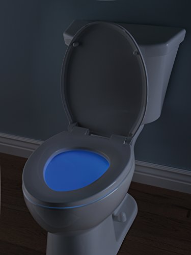 White elongated toilet with dark gray seat, blue nightlight ring, and open lid against dark wall.