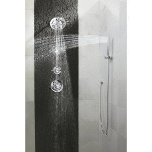 Chrome shower trim kit with multiple spray functions and vertical hand shower rail against dark tile wall.