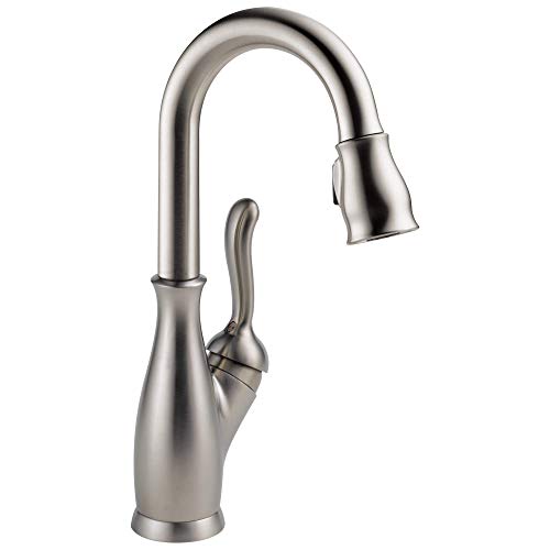 Stainless steel faucet with curved spout, single handle lever, and pull-down spray head.