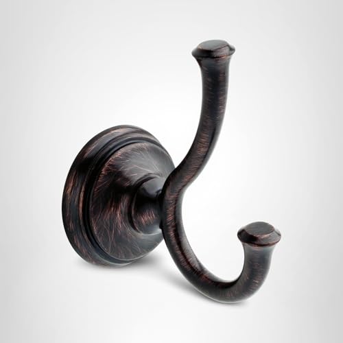 Bronze double robe hook with curved arms and circular wall-mounted base plate.