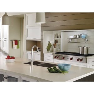 Brushed nickel single robe hook mounted on white cabinetry in modern kitchen setting.