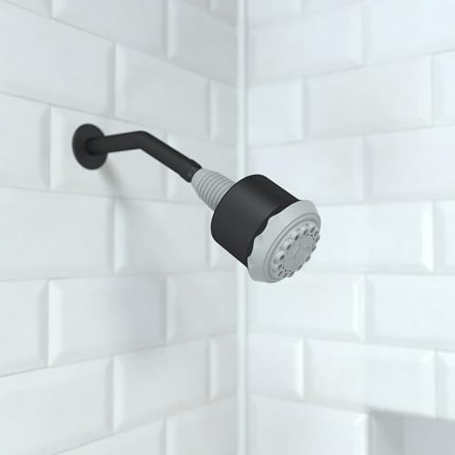 Matte black shower head with curved arm mounted on white subway tile wall.