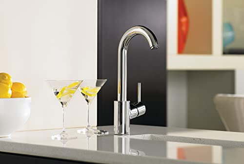 Chrome curved-spout kitchen faucet with single lever handle mounted on white countertop.