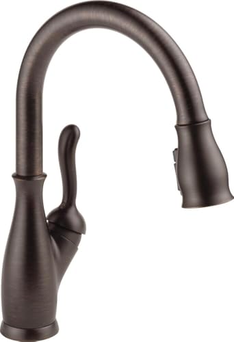 Dark bronze single-handle kitchen faucet with pull-down sprayer and curved spout.