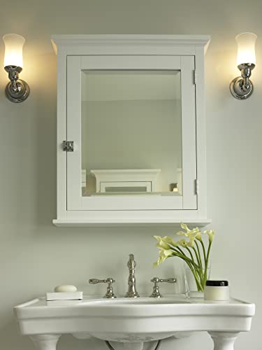 Antique brass widespread lavatory faucet with high arc spout mounted on white pedestal sink below mirror cabinet.