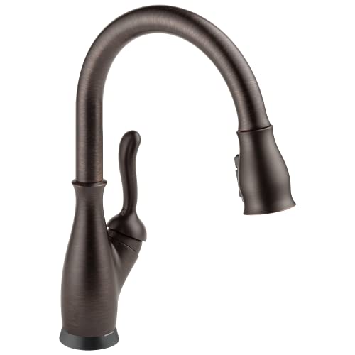 Bronze pull-down kitchen faucet with single curved handle and flexible spray head.