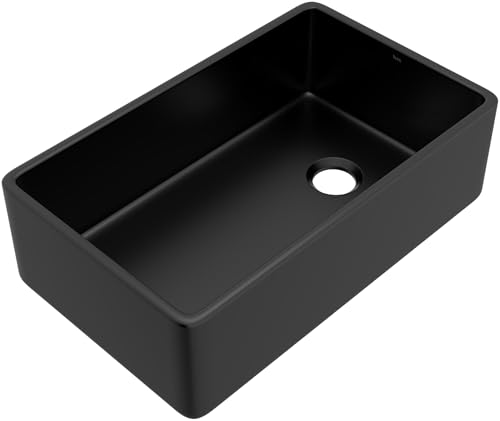 Black fireclay farmhouse apron front kitchen sink with single bowl and drain hole.