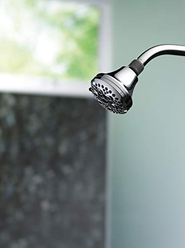 Chrome shower head with multiple spray holes mounted on curved arm against blurred bathroom background.