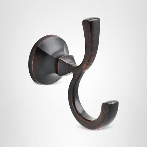 Oil-rubbed bronze robe hook with double curved hooks mounted on circular wall plate.