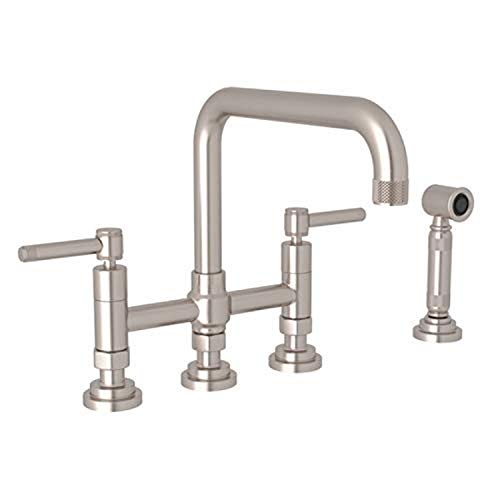 Satin nickel bridge kitchen faucet with high curved spout, dual handles, and detached side spray.