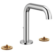 Chrome widespread lavatory faucet with high curved spout and two brass-finished handle bases.
