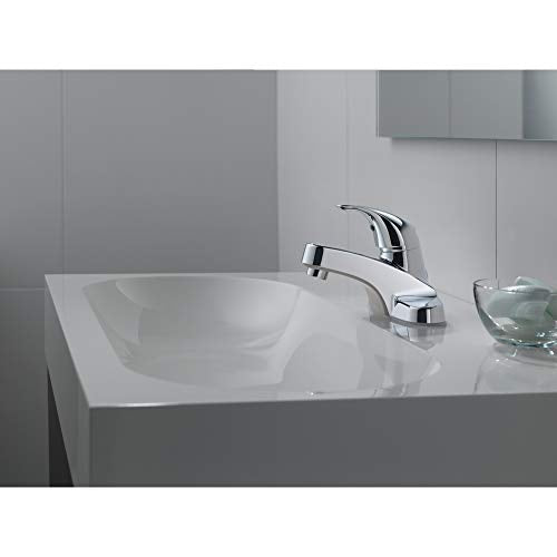 Chrome single-handle bathroom faucet with curved spout installed on white sink countertop.