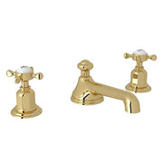 Unlacquered brass widespread lavatory faucet with low spout and cross handles.