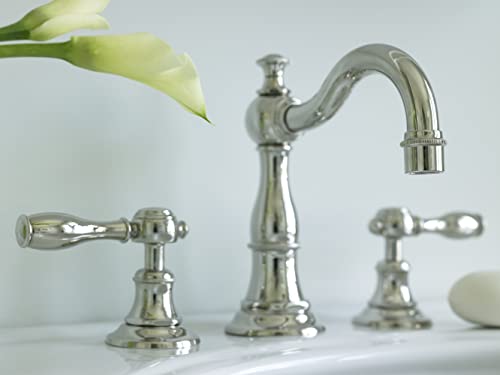 Polished nickel three-piece widespread bathroom faucet with curved spout and lever handles on white sink.