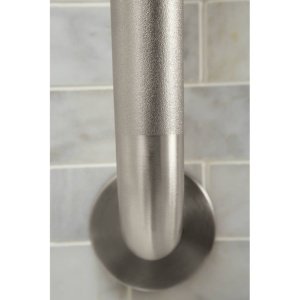Brushed stainless steel grab bar with peened finish and circular mounting flange against tiled wall.