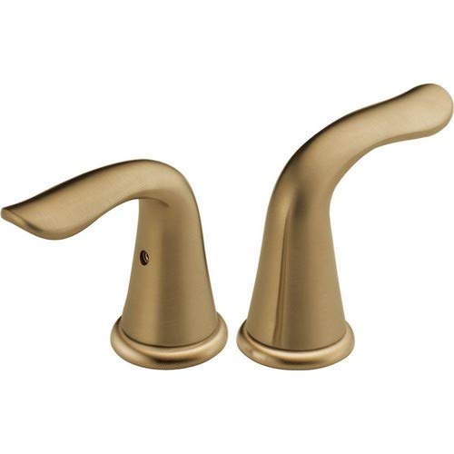 Two champagne bronze lever handles with curved spouts and circular base rings for bathroom faucet installation.
