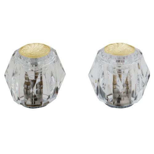 Two clear faceted knobs with polished brass tops and metallic valve stems visible inside.