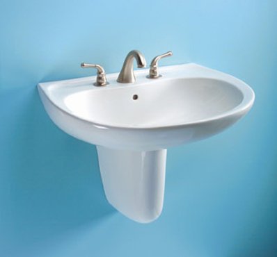 White oval wall-mounted bathroom sink with chrome faucet and handles against blue background.