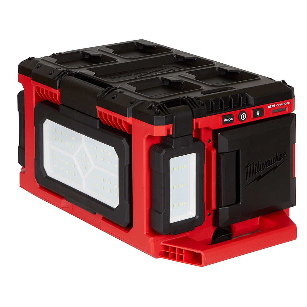 Milwaukee M18 PACKOUT light and charger unit with red and black plastic housing, dual LED light panels, and charging ports on