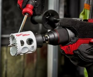 Milwaukee 5" bi-metal hole saw with red and black drill attachment mounted on power drill.