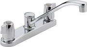 Chrome two-handle kitchen faucet with curved spout and knob controls on white base.