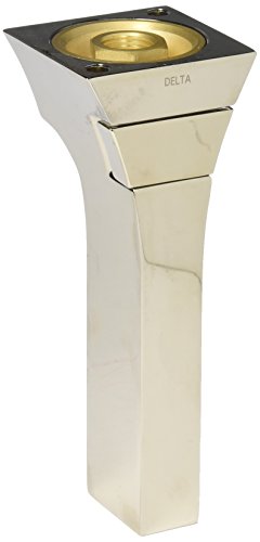 Polished nickel tub spout with pull-up diverter and cream-colored tapered mounting base.