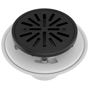 Round matte black shower drain with radial slot pattern and white trim ring for tile installation.