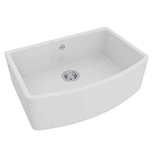 White fireclay farmhouse sink with curved apron front, single bowl, and chrome drain fixture.