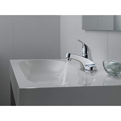 Chrome single-handle bathroom faucet with curved spout mounted on white countertop sink.