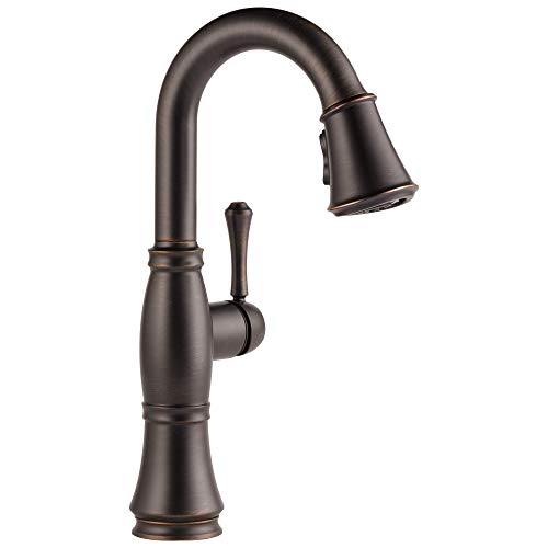 Oil-rubbed bronze bar faucet with curved spout, single handle, and pull-down spray head.