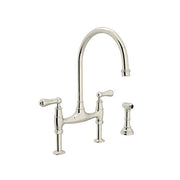 Polished nickel bridge kitchen faucet with high arched spout, two handles, and matching side spray attachment.