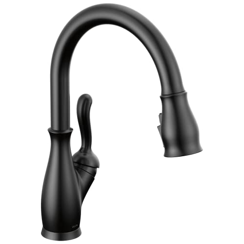 Matte black pull-down kitchen faucet with single handle and curved spout.